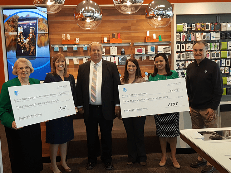 Check Presentation for Student Scholarships (L to R): Nancy Smith (green), Utah Valley University; Tara Thue, AT&T Director of External Affairs; Mayor Brunst (middle); Elizabeth and Jackie Perkins, Latinos in Action.