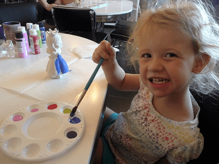 Olivia painting ceramic at Lulu's Crafty Corner in Payson.