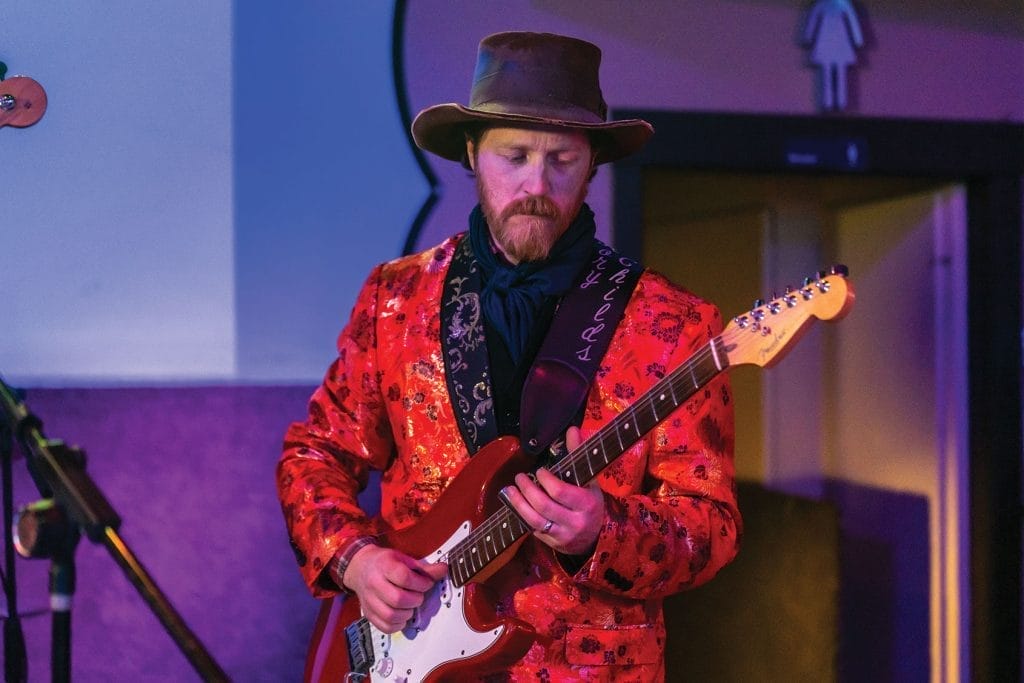 Rory Childs (guitar) perform at Black Jack’s Bar with Social Soup.