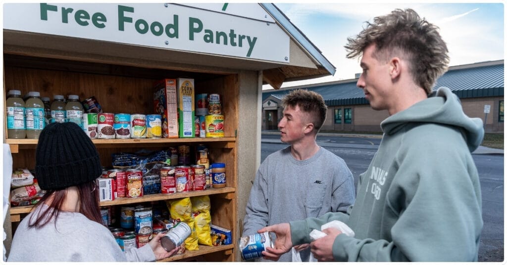 During a photo shoot, a group of young adults, serving on behalf of their employer, paused to make a difference by restocking the food pantry and lending a helping hand.