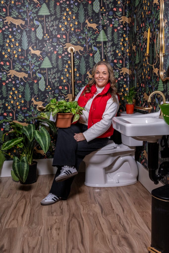 Carrie Felt showcases a potted plant in the shop’s charmingly dubbed ‘cutest bathroom you’ve ever seen.
