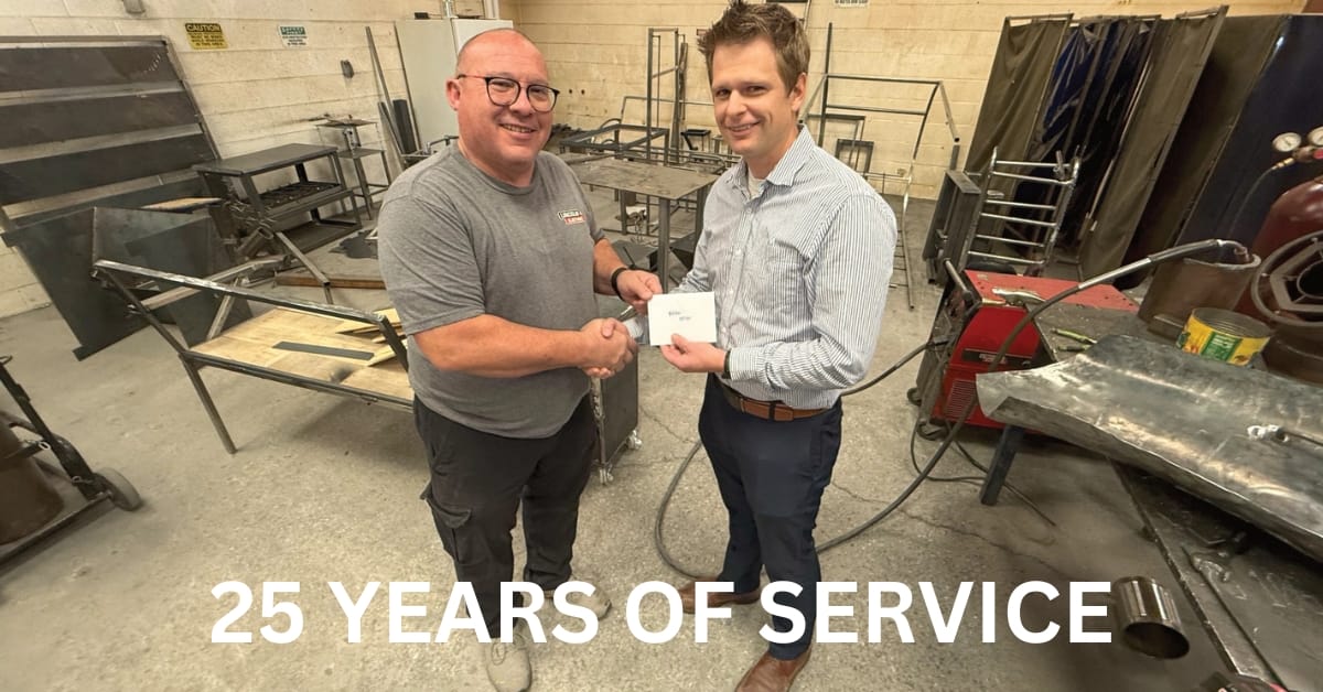 L-R: Springville High School Welding Teacher Brian Ostler and Bryce Packard with Springville Central Bank.